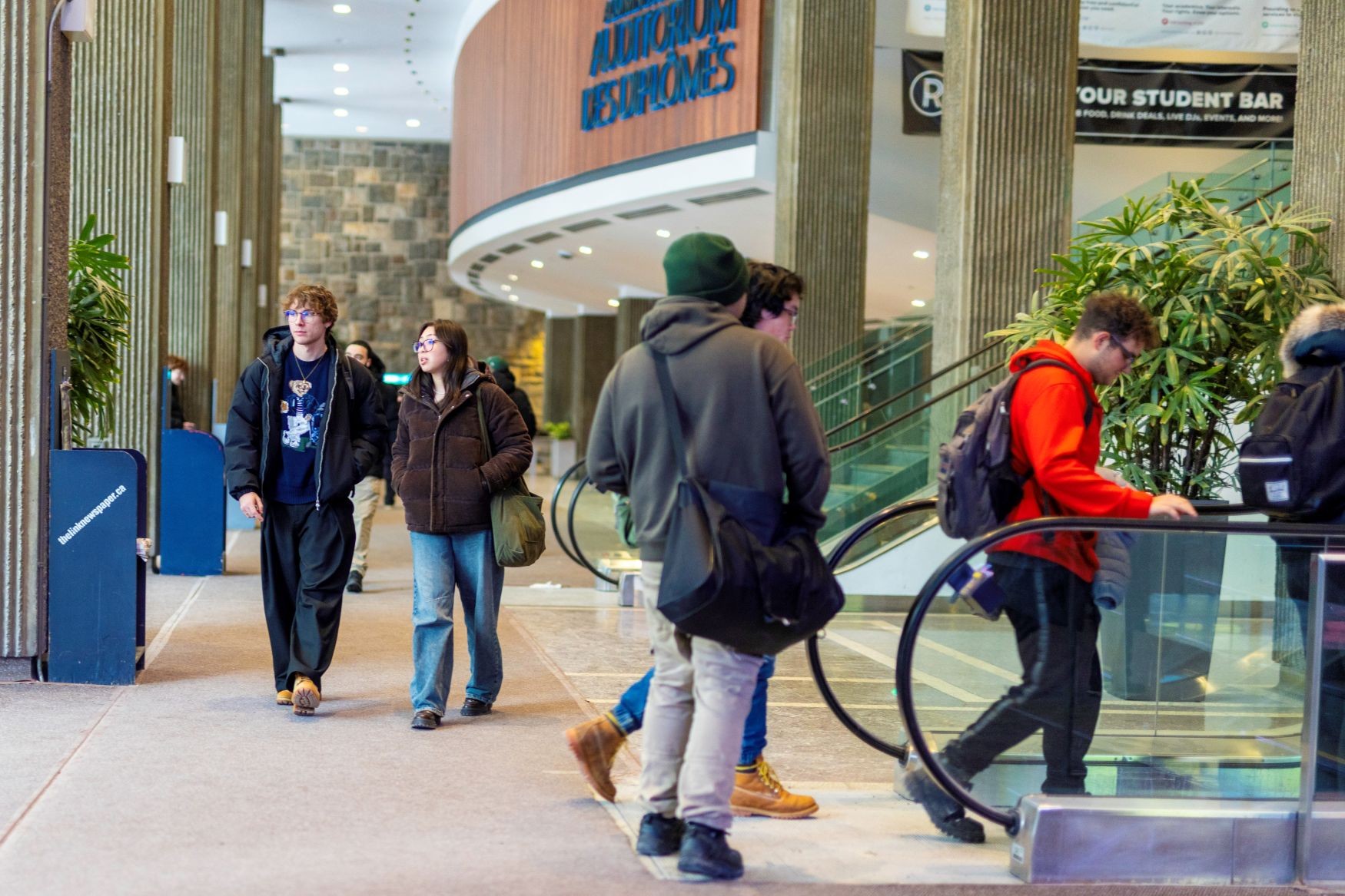 A photo of students walking in the Hall Building on the downtown campus
