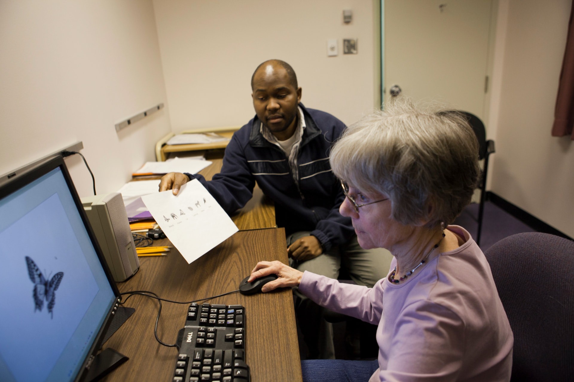 Cognitive Science researcher and subject in front of a computer-controlled test
