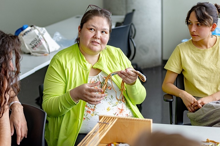 A woman display Indigenous weaving