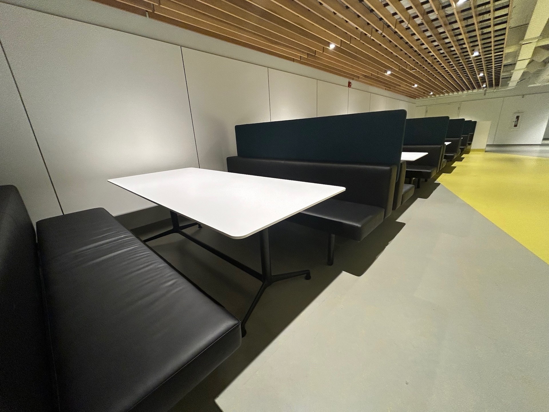 Dining area with several booths and tables in Faubourg Building S120