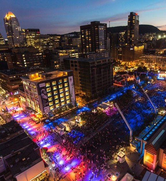A vibrant aerial night view of the Festival International de Jazz de Montréal