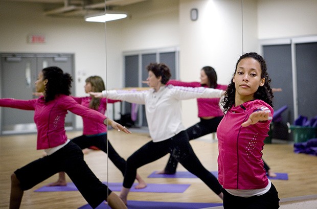 Instructor leads students in a yoga class at Le Gym