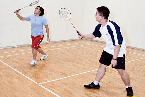 Two students playing badminton at Le Gym in Concordia's downtown campus