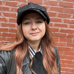 White woman with brown hair smiling, close up of just her head.