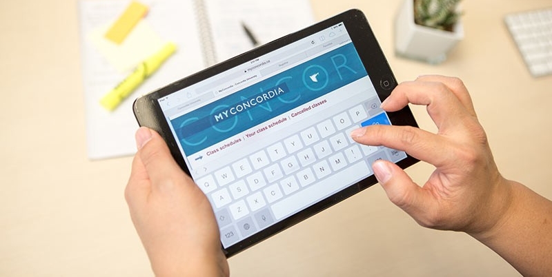 "" Top-down view of a user logging into My Concordia portal on a tablet computer