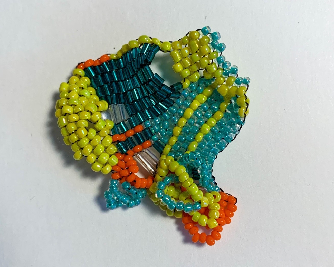 multicolored beadwork, counter-mapping turtle island territories. glass beads yellow,turquoise, navy blue, and orange
