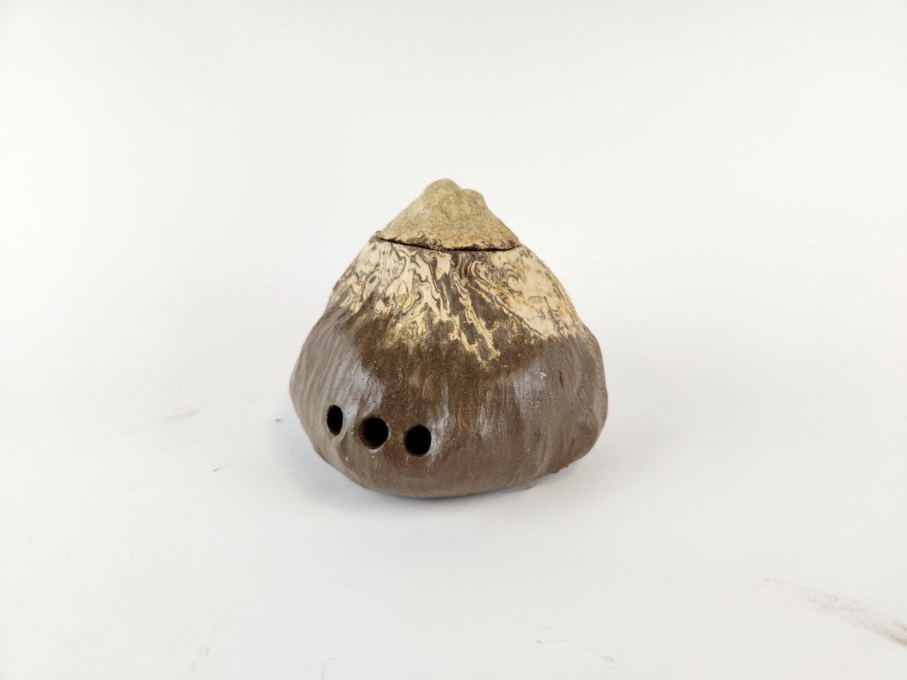 Wandering Earthscapes Textured cone shaped brown and beige ceramic vessel, on white background