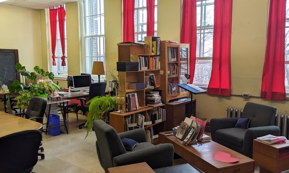 Office with windows, red curtains and book shelves