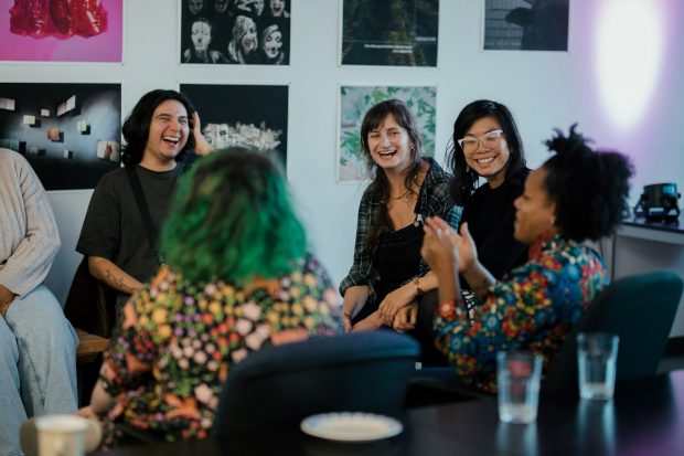 A group of people chatting and laughing