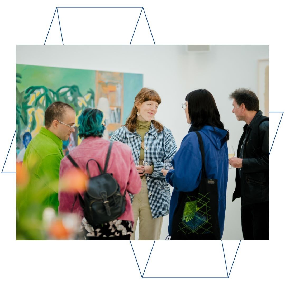 People talking at an art event