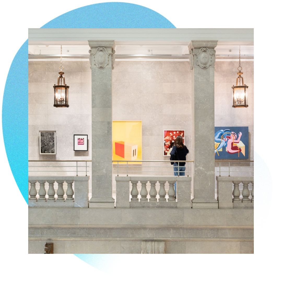 Someone looking at artworks in an exhibition.