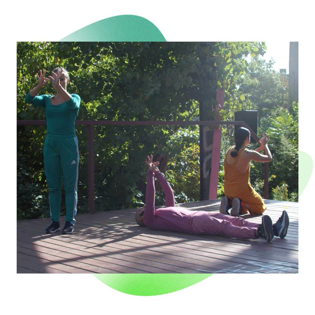 Three people dancing on an outdoor stage