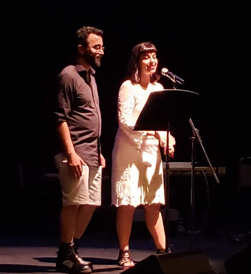 Abjad Howse Collective and Emma Haraké Two people speaking into a microphone.