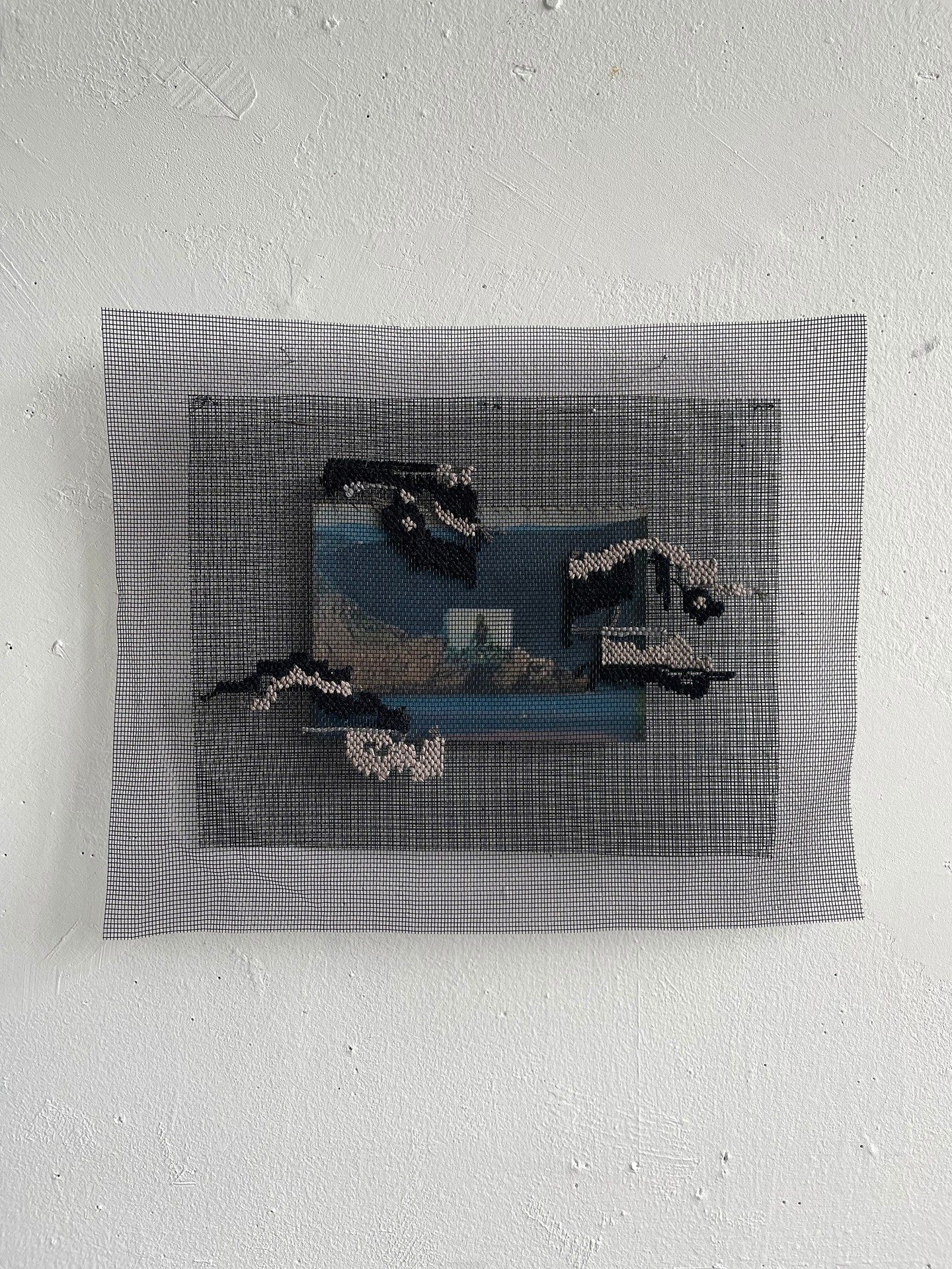 artwork on a wall: a layered sculpture/image of a landscape