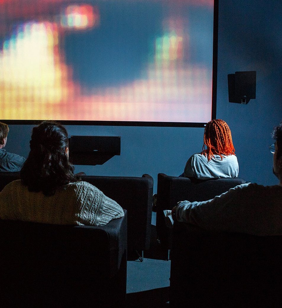 a group of Film Studies students watching a film screening 