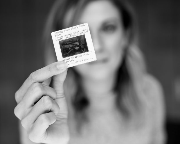 A woman examining a photographic slide