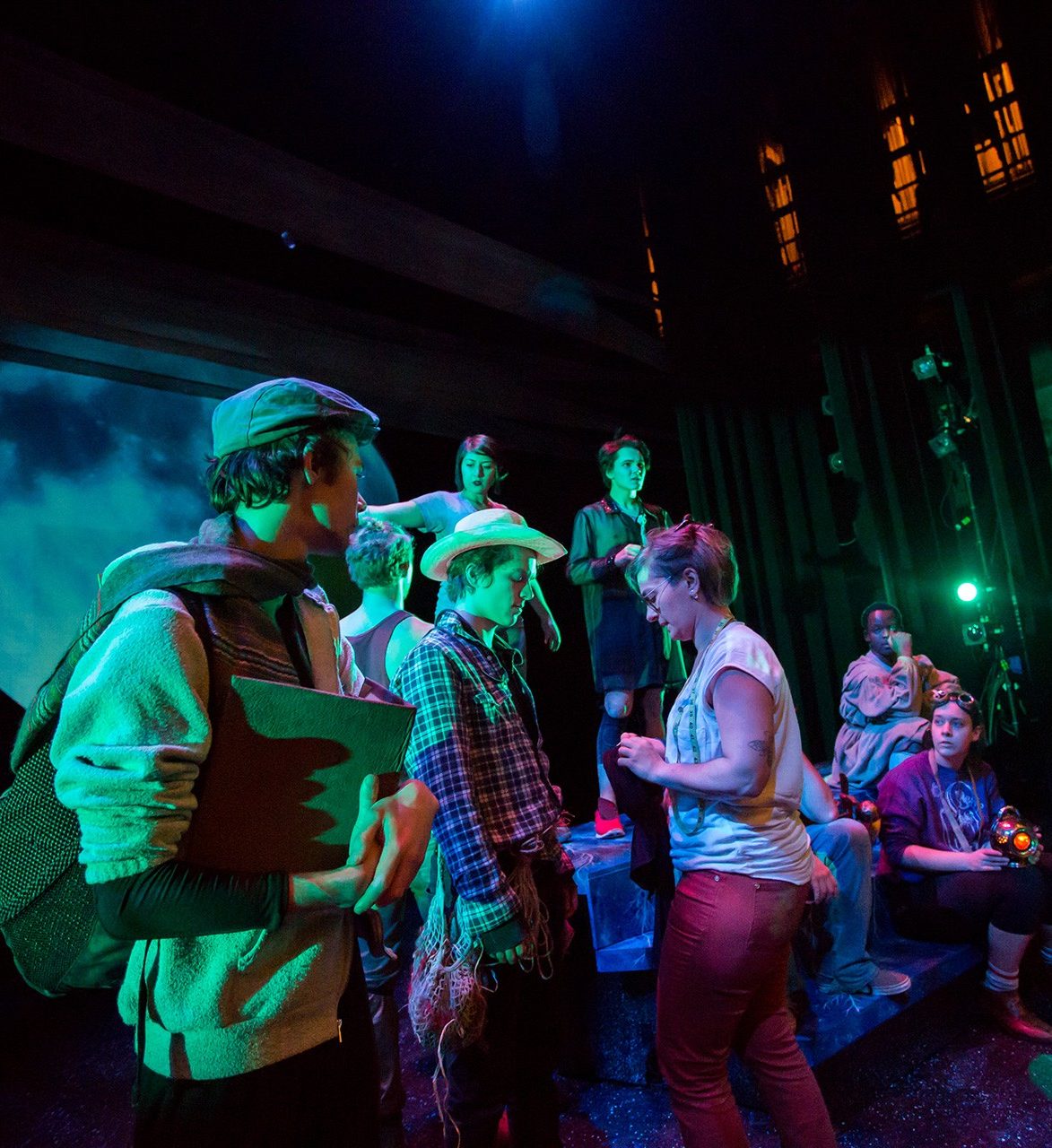 Creative Arts Therapies Drama therapy prepare for a performance on a dark stage in costume.