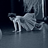 Female dancer in a ballerina skirt on a stage in a push-up position