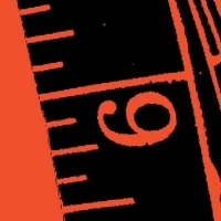 Close up of orange and black graphic that looks like a tape measure.