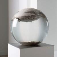 Glass orb filled with water and clay