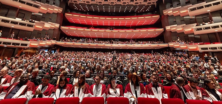 Auditorium filled with university graduates at convocation ceremony