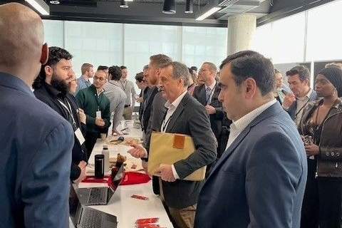 Group of people on both sides of a long table talking to each other