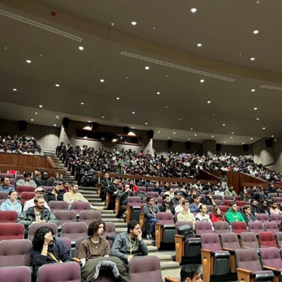 Group of people seated inside an auditorium