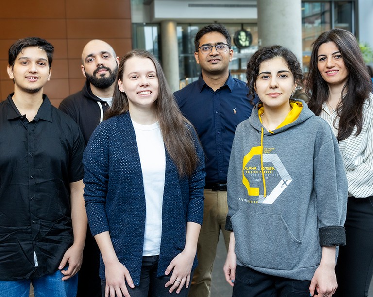Group photo of people standing in a lobby