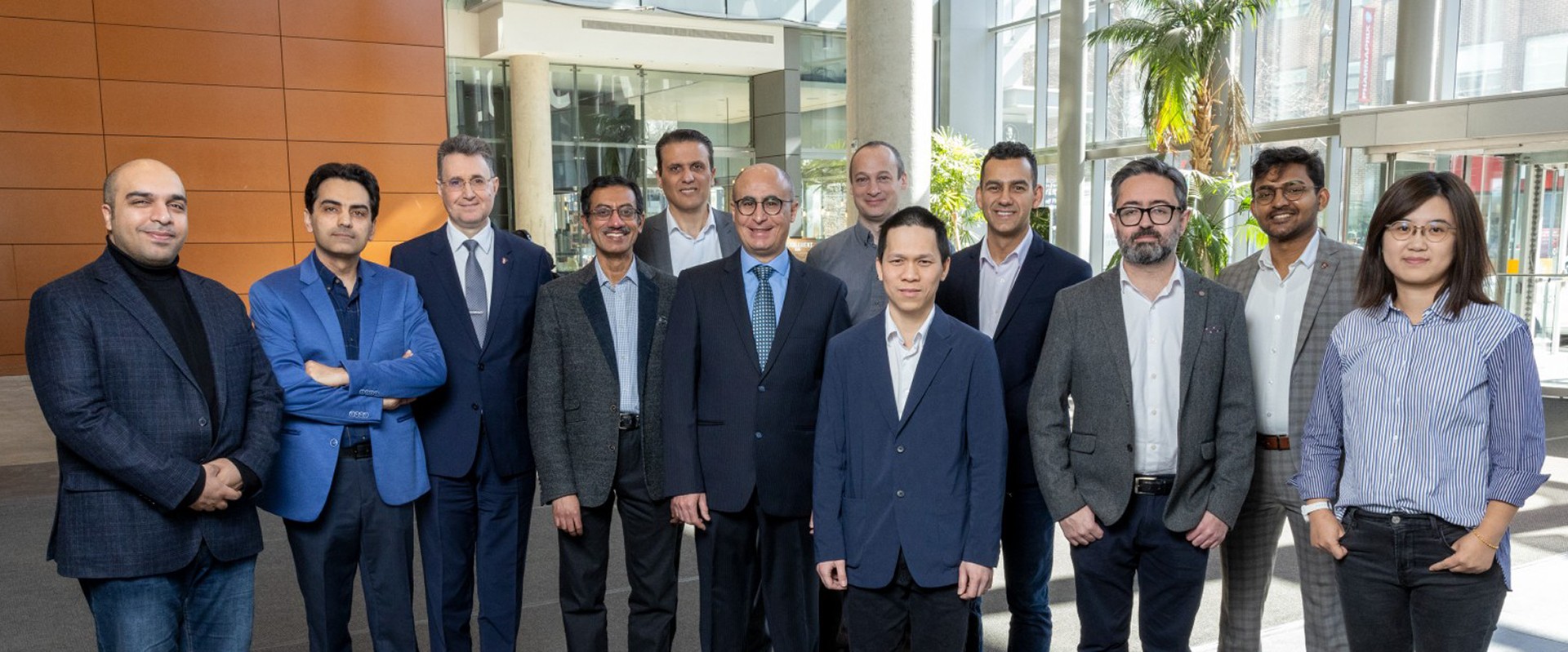 Group photo of well-dressed people standing in a lobby