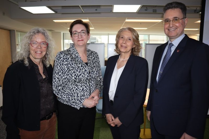 Group photo of well-dressed people standing in an office