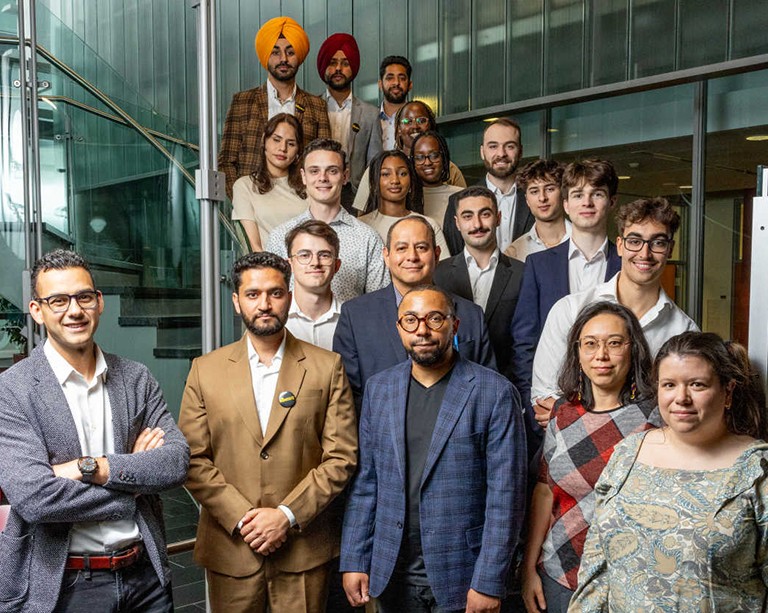 Group photo of well-dressed people on a staircase