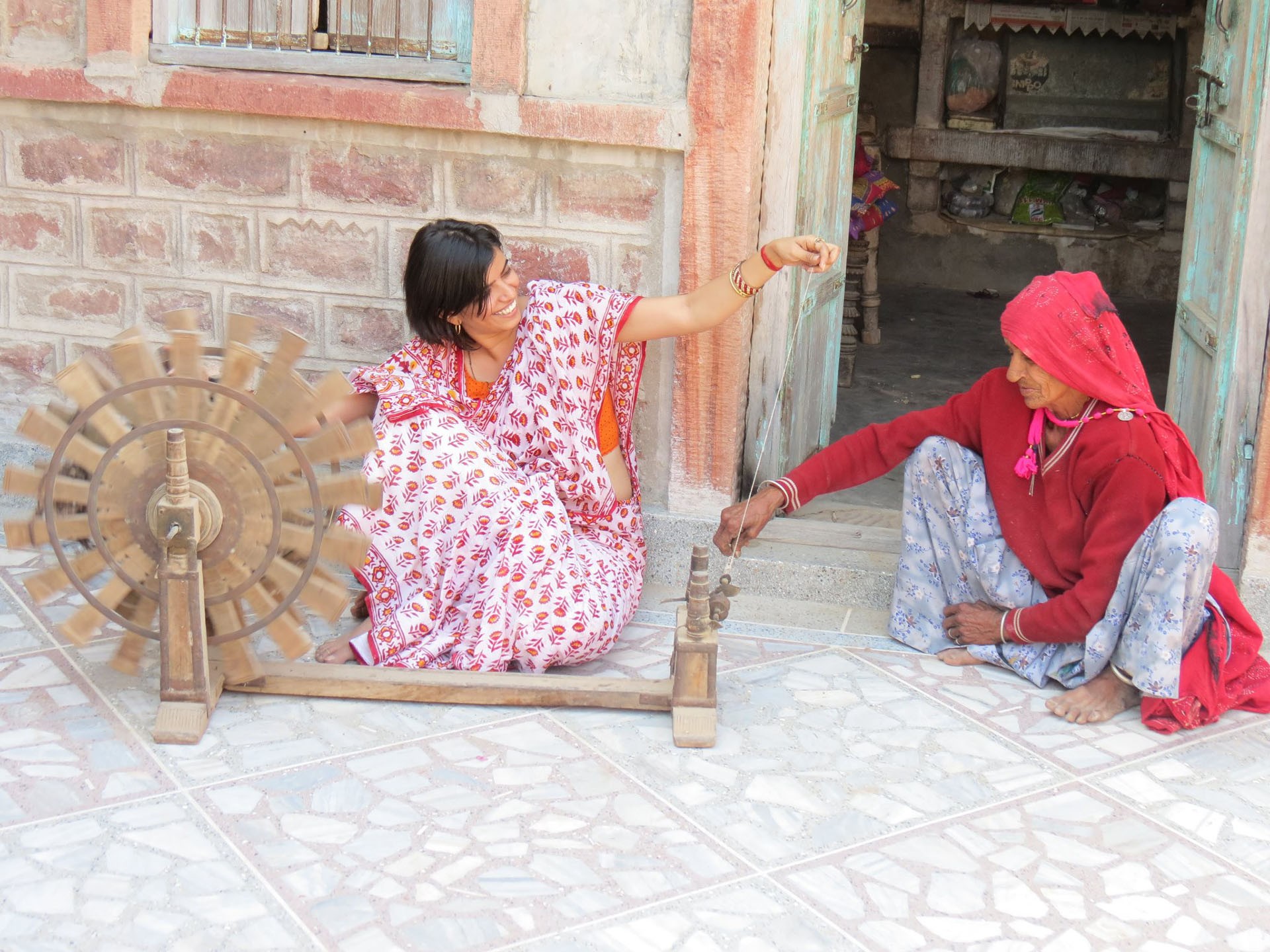 Pramila sits beside her naani, who teaches her to spin yarn on a charkha (spinning wheel) during a summer visit to their village, Kapuria, in Rajasthan’s Thar Desert.