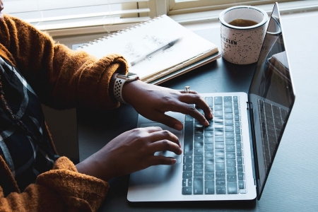 Typing on a laptop