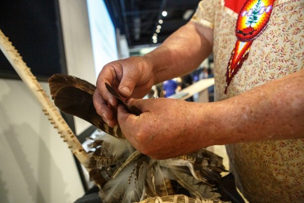 close-up of hands working with feathers