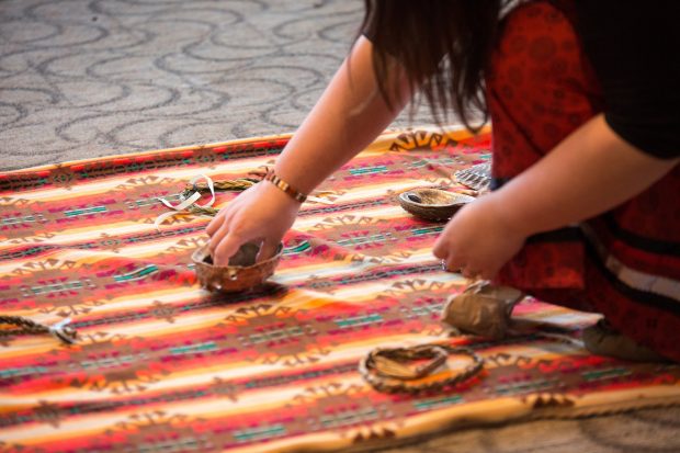 Close-up of hands working on a tapestry