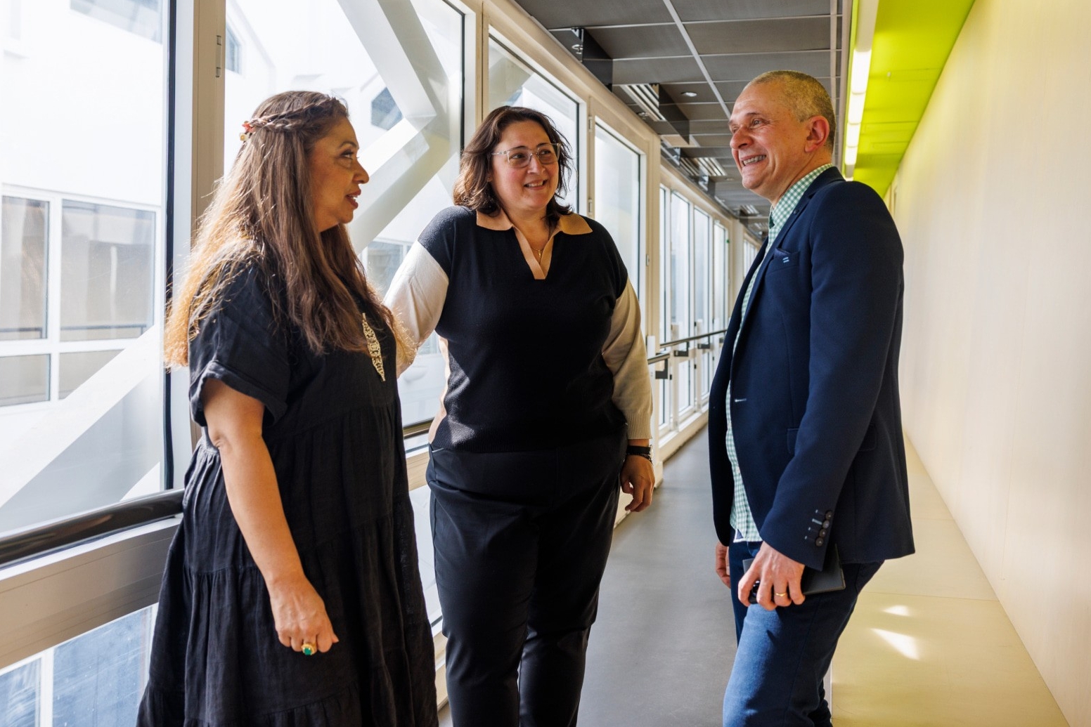 Three colleagues in conversation
