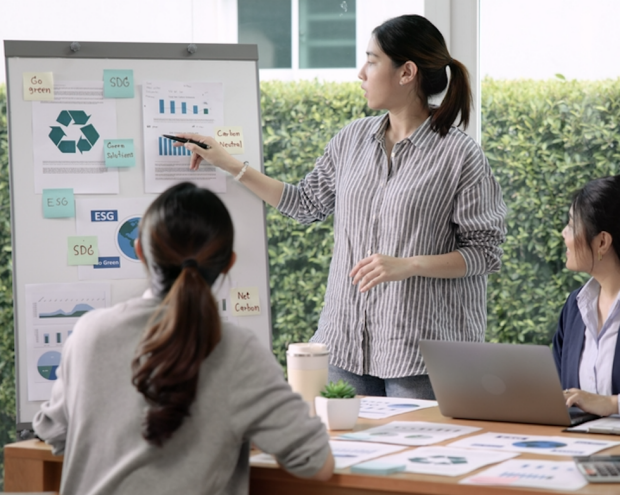 A woman shares ESG communications and marketing strategies with her team