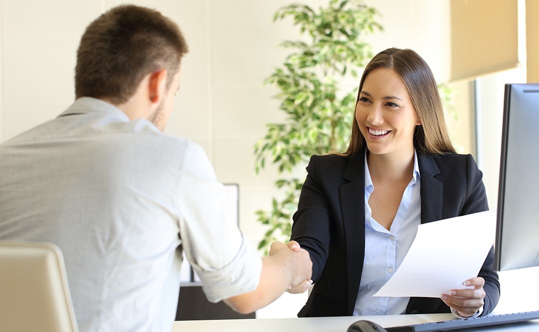 Two individuals sitting at a desk Mock interview