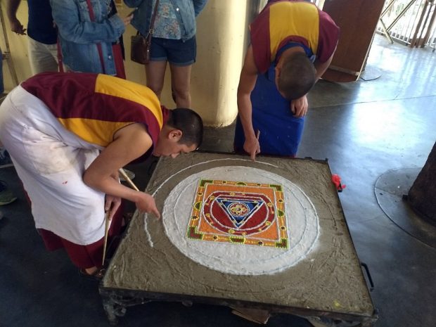 Image: Buddhist monks performing Sand mandala, Karan, CC BY-SA 4.0