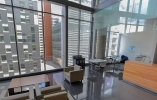 Sixth floor John Molson building lounge with chairs and view of other Concordia buildings