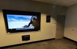 Wall TV showing a video in a soundproofed room