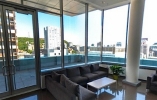 Thumbnail of lounge surrounded by windows with view of city