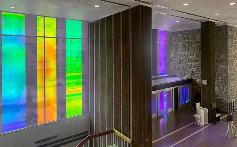 Lobby of a large building with brightly coloured tinted glass windows