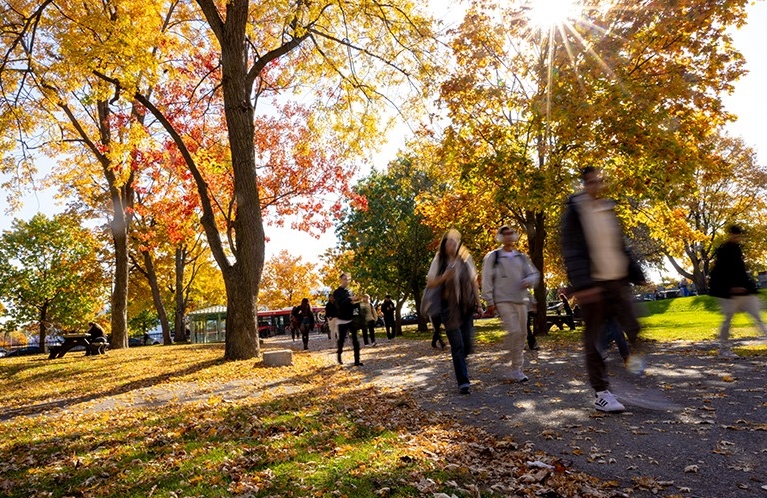 People walking through a university campus during fall