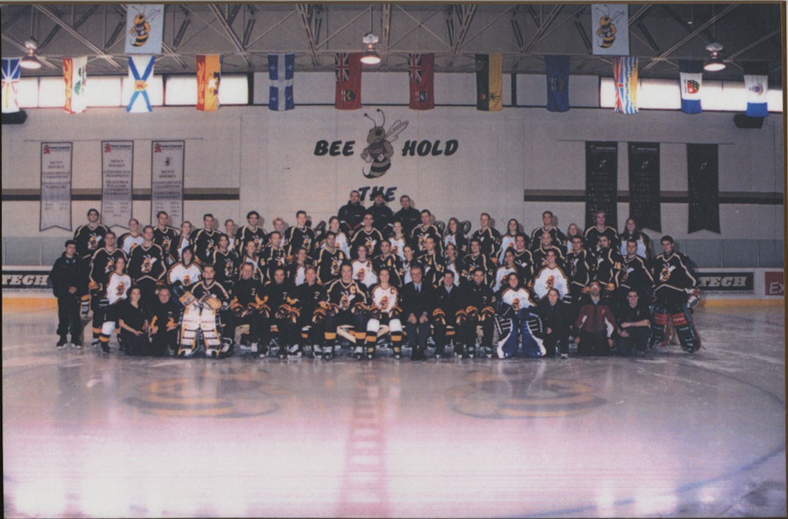 Group photo of Concordia men and women's hockey team at centre ice