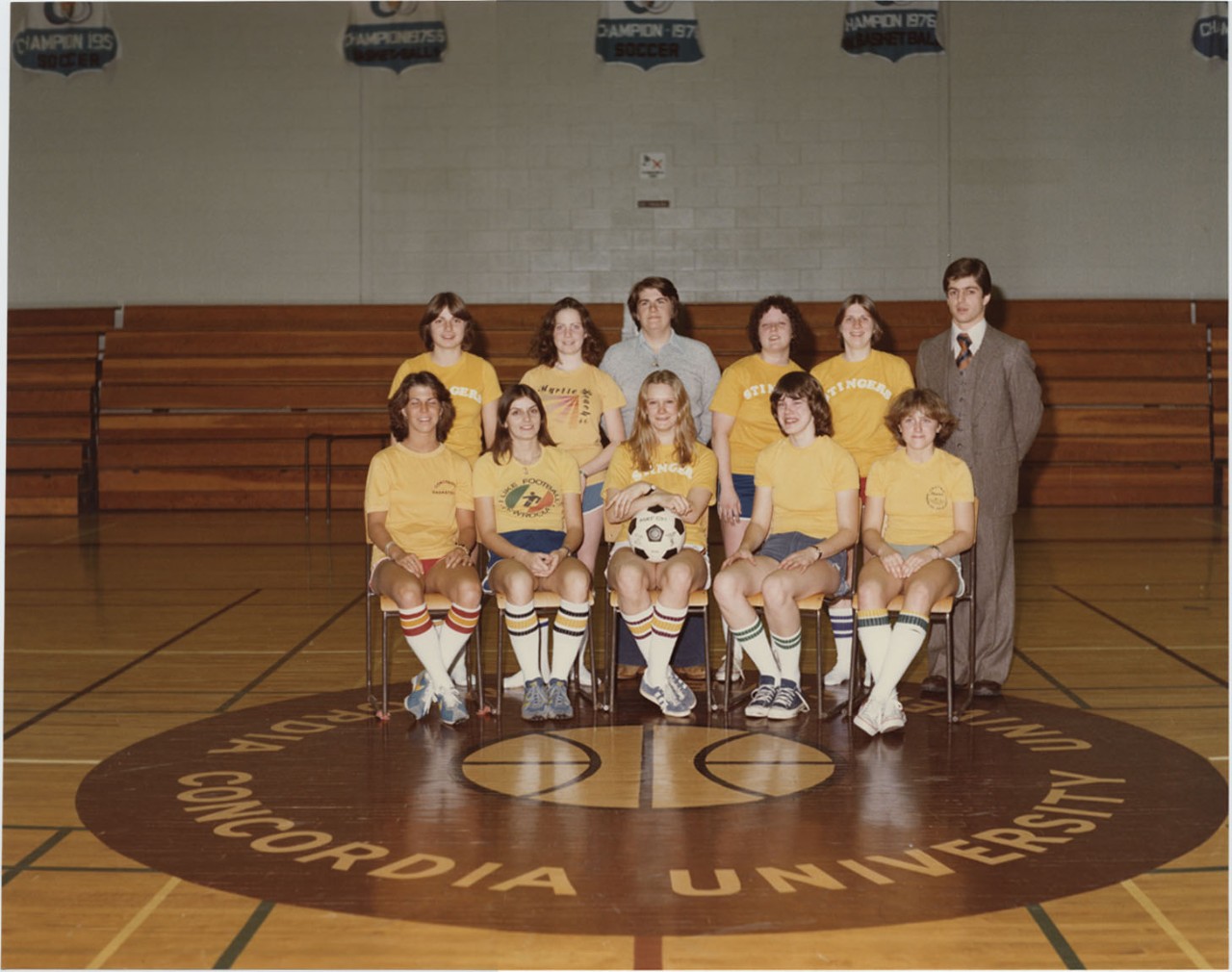 Concordia University women's basketball team group photo along with coach and assistant coach at middle court