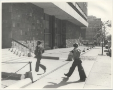 People entering the Hall Building from the side doors
