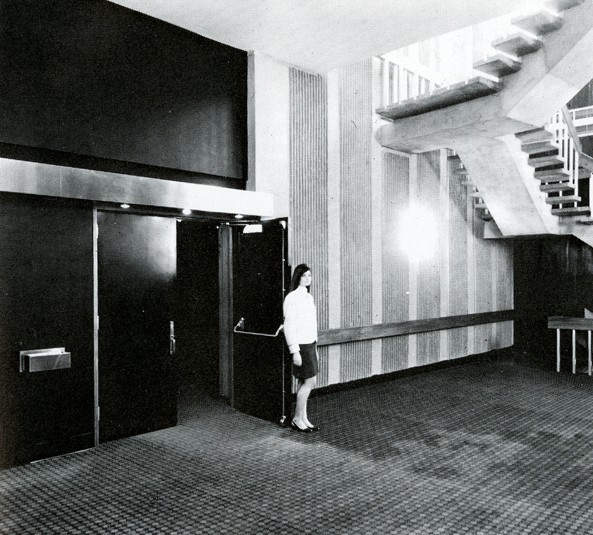 Person standing in front of an opened door near a stairwell