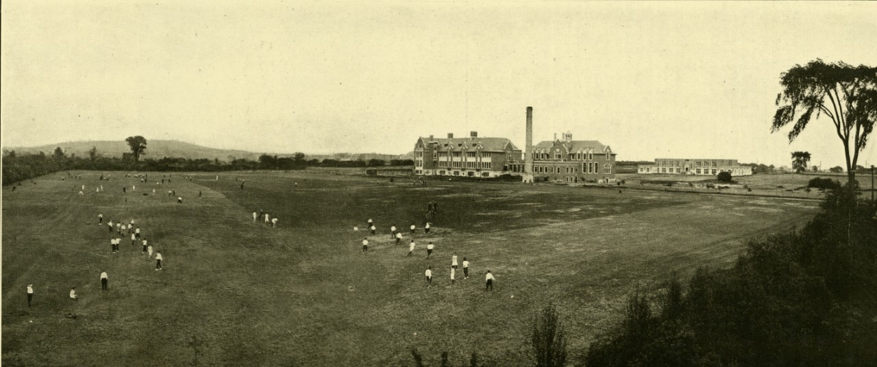 Old photo of buildings in a vast field from Loyola College Review, 1918