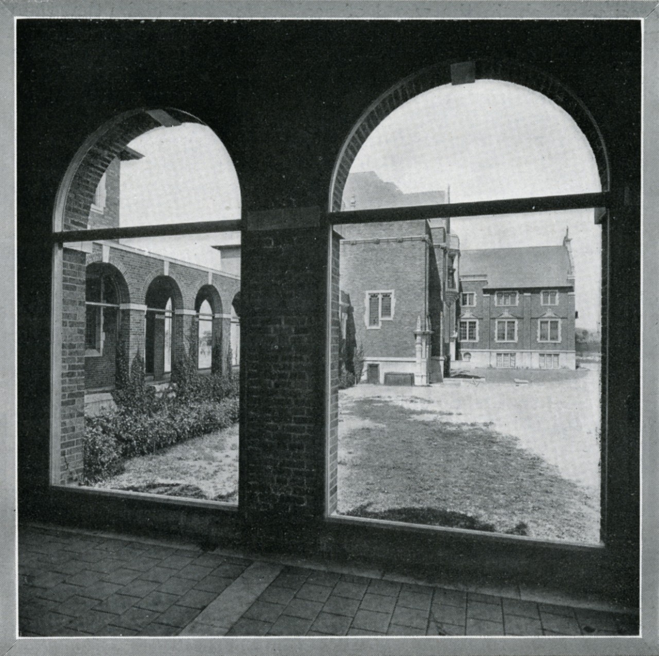 Old black and white photo of looking through non-glass windows in a hallway from Loyola College Review, 1922